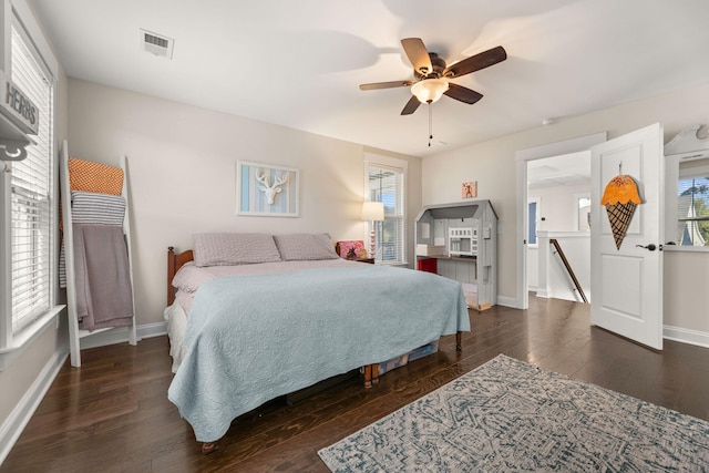 bedroom with dark hardwood / wood-style floors and ceiling fan