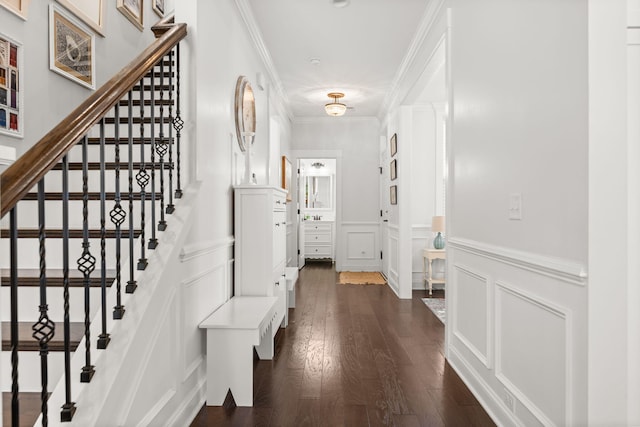 foyer entrance with crown molding and dark hardwood / wood-style floors