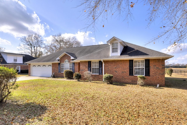 view of front of house featuring a front yard and a garage