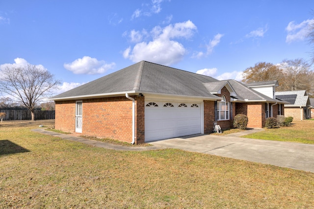 view of front of home with a front yard and a garage