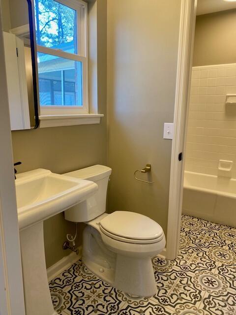 bathroom with tile patterned floors, toilet, and baseboards