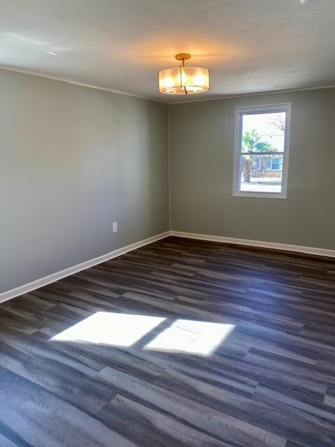 unfurnished room with wood finished floors, baseboards, and ornamental molding