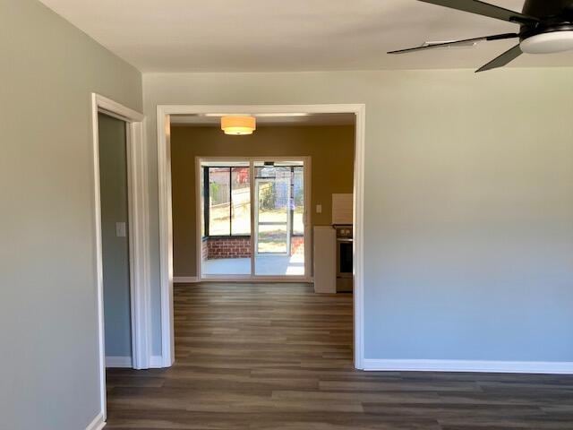 hall with baseboards and dark wood-style floors