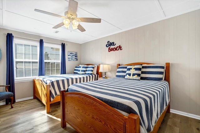 bedroom with hardwood / wood-style floors, crown molding, and ceiling fan