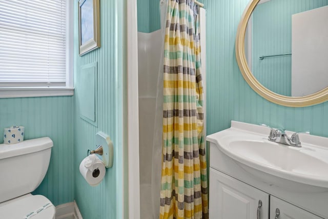 bathroom featuring vanity, toilet, and a shower with shower curtain