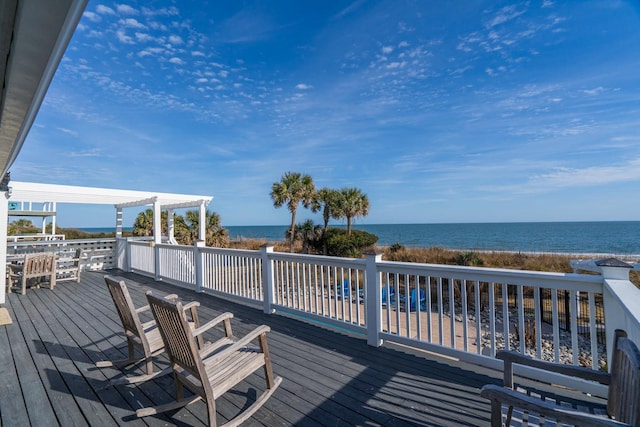 deck featuring a water view and a pergola