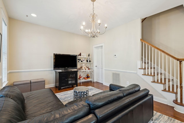 living room featuring dark wood-type flooring and a notable chandelier