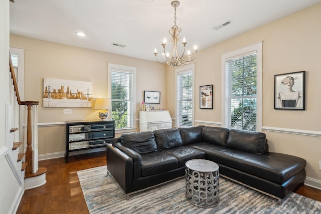 living room featuring dark wood-type flooring and a notable chandelier