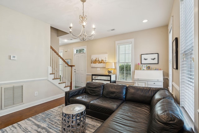 living room featuring hardwood / wood-style floors and a notable chandelier