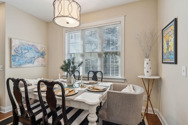 dining space with dark hardwood / wood-style floors