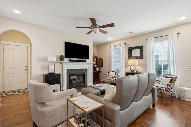 living room with ceiling fan and dark hardwood / wood-style flooring