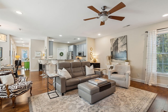 living room featuring ceiling fan and wood-type flooring