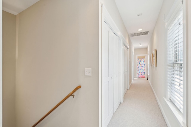 corridor with light colored carpet