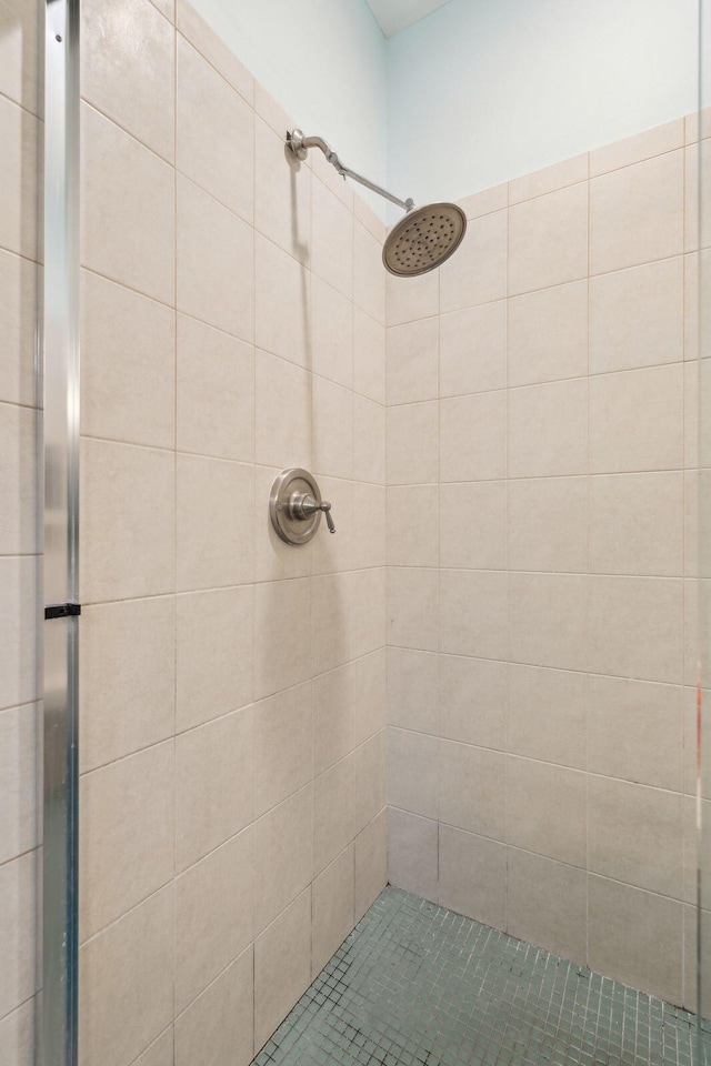 bathroom with a tile shower