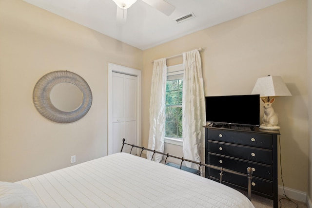 carpeted bedroom with ceiling fan and a closet