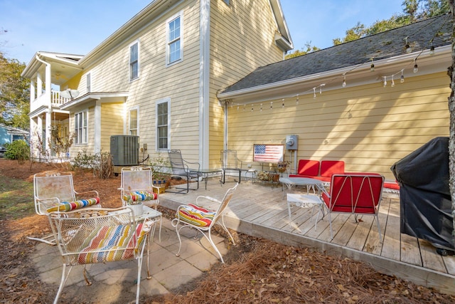 rear view of house with cooling unit and a wooden deck