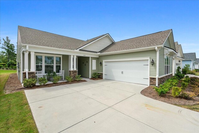 craftsman-style house with a garage and a front lawn