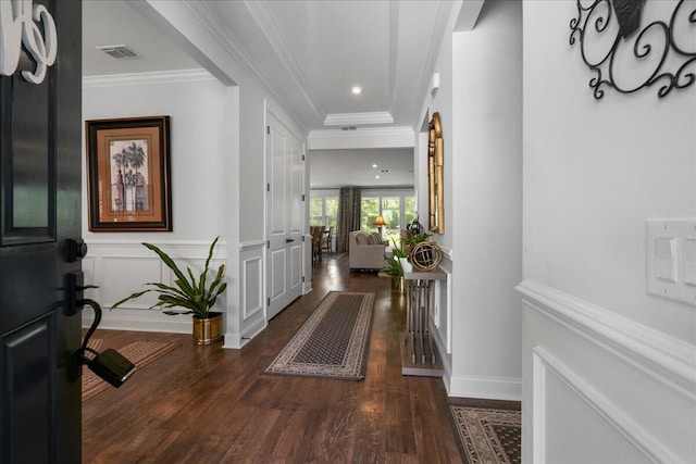 foyer featuring dark wood-type flooring and ornamental molding