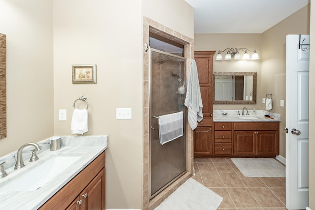 bathroom with tile patterned floors, vanity, and walk in shower