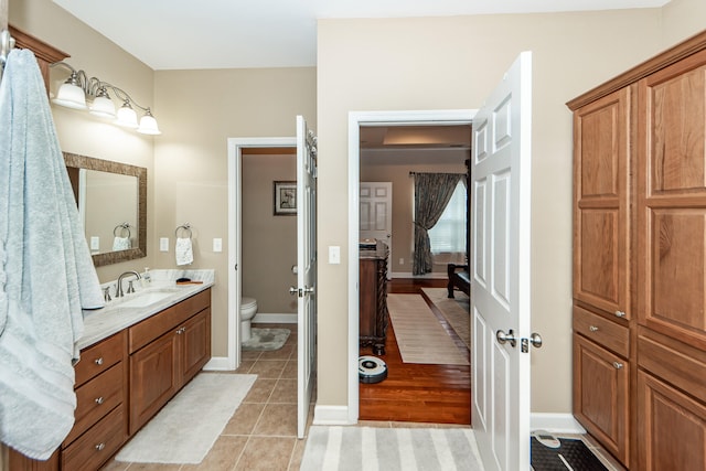 bathroom with vanity, toilet, and wood-type flooring