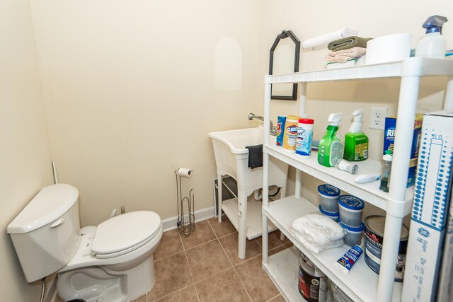 bathroom with tile patterned flooring and toilet