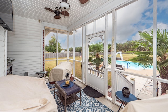 sunroom featuring ceiling fan