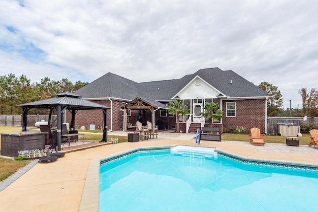 view of pool featuring a gazebo, a patio, and a sunroom