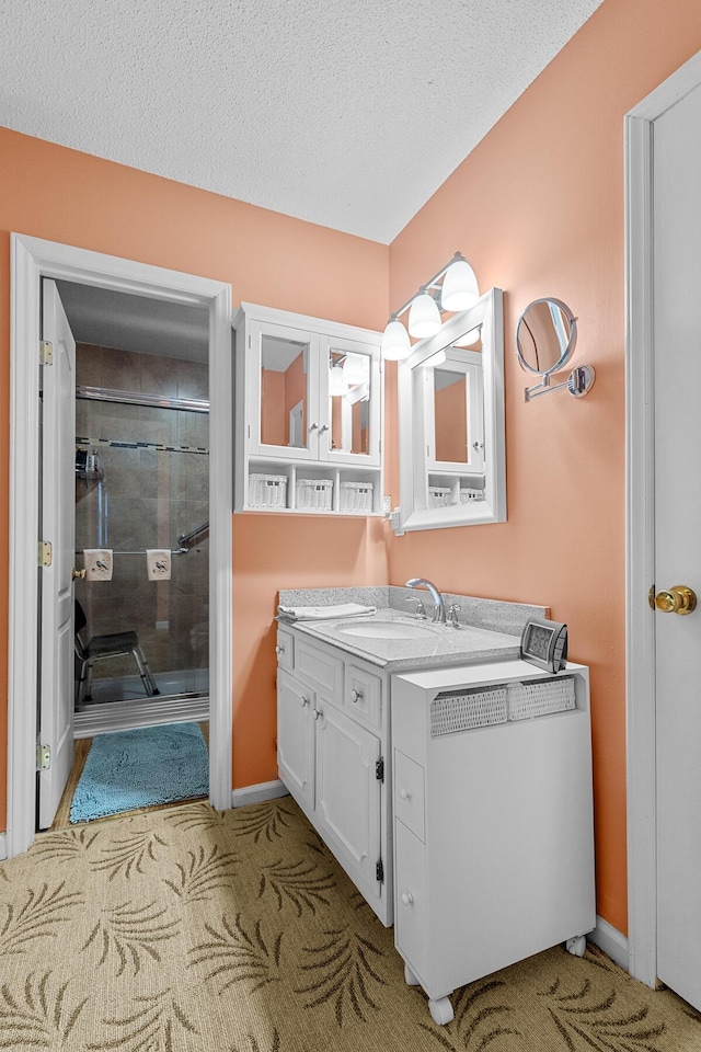 full bathroom with radiator heating unit, a textured ceiling, a stall shower, vanity, and baseboards