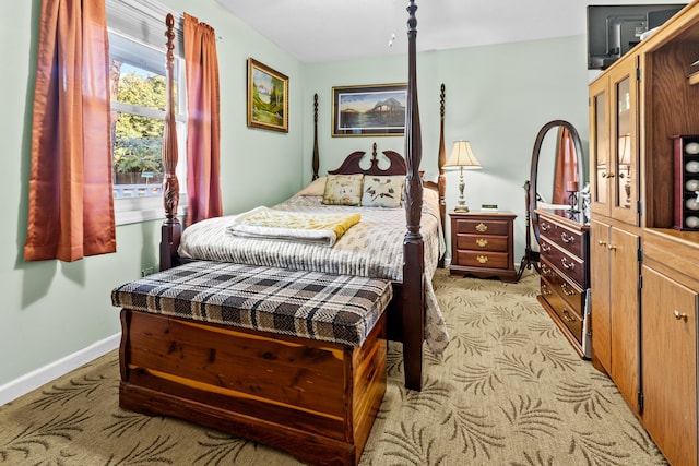 bedroom featuring light colored carpet and baseboards