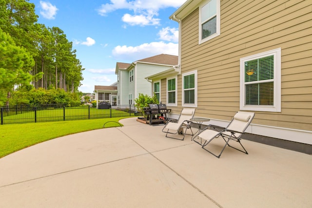 view of patio with area for grilling and fence