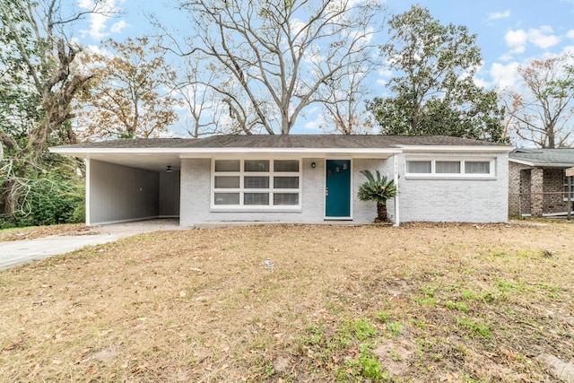 single story home featuring a carport and a front yard