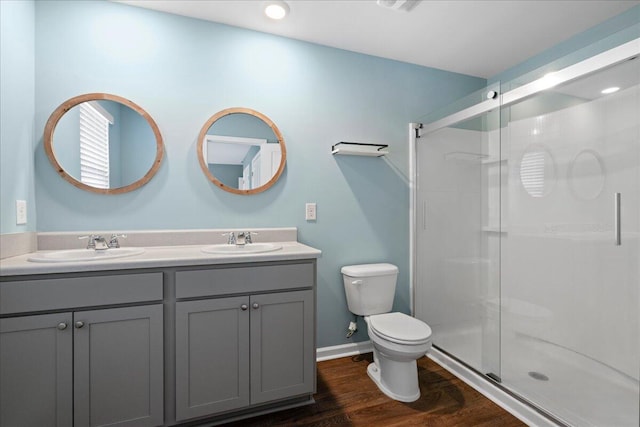 bathroom with an enclosed shower, hardwood / wood-style floors, toilet, and vanity