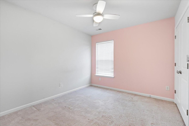 unfurnished room featuring ceiling fan and light carpet