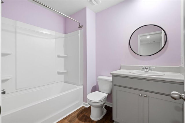 full bathroom featuring vanity, toilet, hardwood / wood-style flooring, and shower / washtub combination