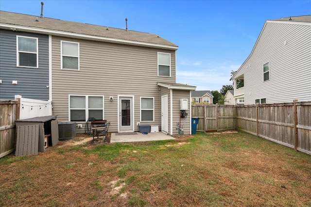 rear view of house with a yard, a patio, and central air condition unit