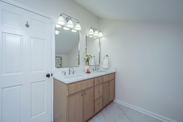 bathroom with vanity and vaulted ceiling