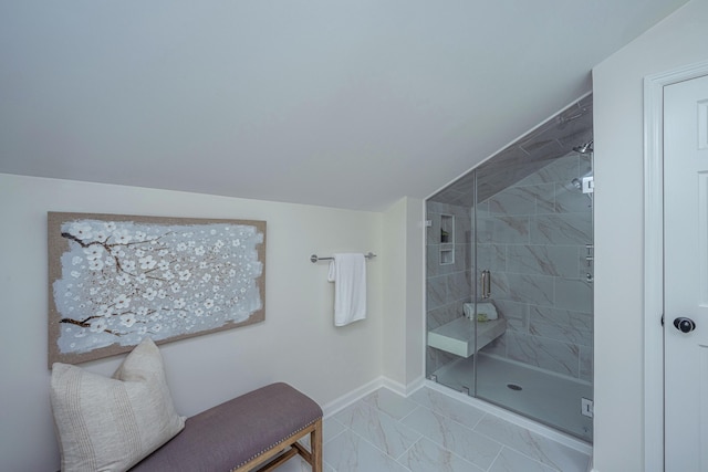 bathroom with lofted ceiling and a shower with shower door