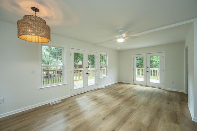 interior space with ceiling fan, light wood-type flooring, and french doors