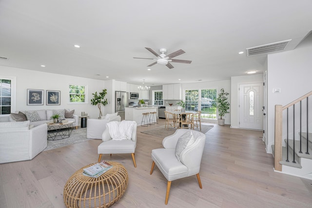 living room featuring light wood-type flooring and ceiling fan