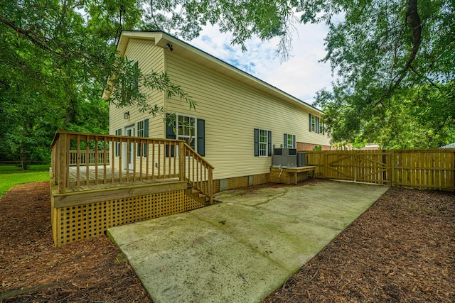 rear view of house featuring a deck and a patio area