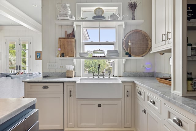 732 Gate Post Dr, Mount Pleasant, SC 29464 - kitchen with open shelves, white cabinetry, and light stone counters