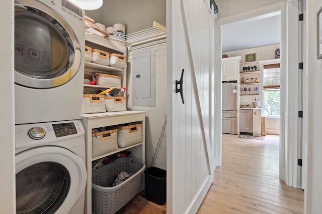 732 Gate Post Dr, Mount Pleasant, SC 29464 - laundry area featuring stacked washer and clothes dryer, light wood finished floors, and electric panel