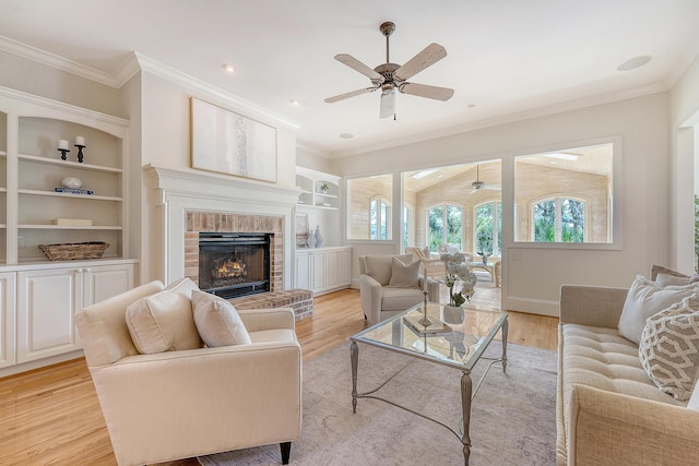 3331 Cottonfield Dr, Mount Pleasant, SC 29466 - living area with a ceiling fan, light wood-type flooring, a brick fireplace, crown molding, and built in shelves