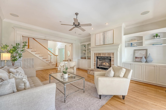 3331 Cottonfield Dr, Mount Pleasant, SC 29466 - living area featuring ceiling fan, stairs, ornamental molding, light wood-style flooring, and a fireplace