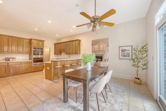 3331 Cottonfield Dr, Mount Pleasant, SC 29466 - dining space featuring light tile patterned floors, a fireplace, a ceiling fan, baseboards, and recessed lighting