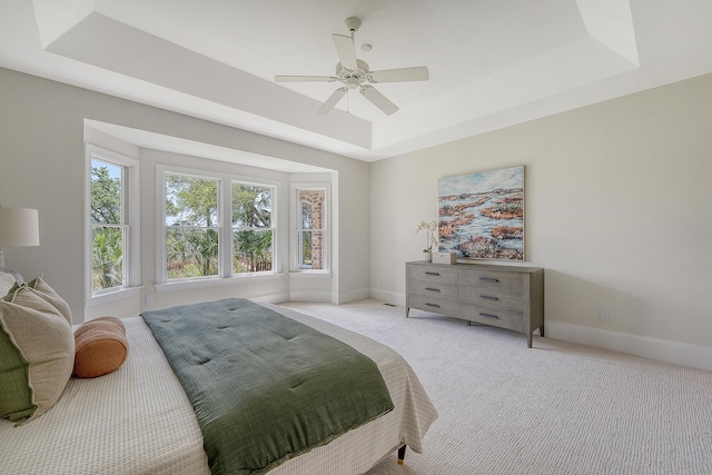3331 Cottonfield Dr, Mount Pleasant, SC 29466 - bedroom with a tray ceiling, baseboards, light carpet, and a ceiling fan