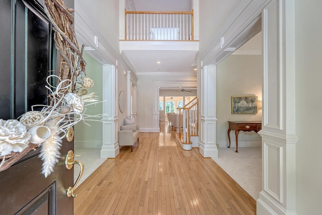 3331 Cottonfield Dr, Mount Pleasant, SC 29466 - entryway featuring baseboards, light wood-style flooring, ornamental molding, decorative columns, and a towering ceiling