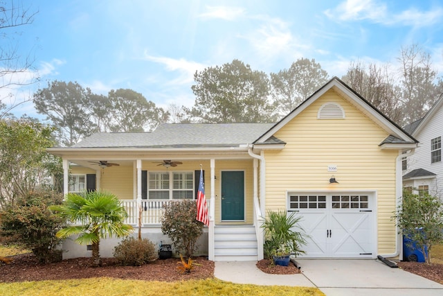 view of front of home with ceiling fan, a garage, and a porch