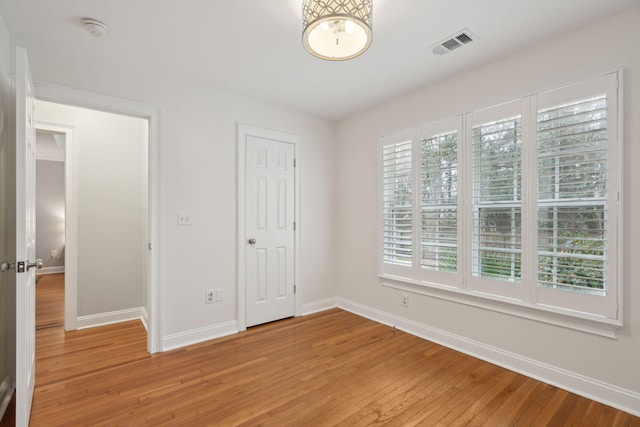 unfurnished bedroom with a closet and light wood-type flooring