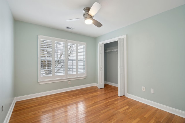 unfurnished bedroom featuring a closet, ceiling fan, and light hardwood / wood-style flooring